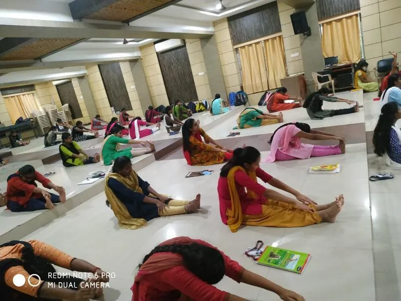Students practising a seated forward bend
