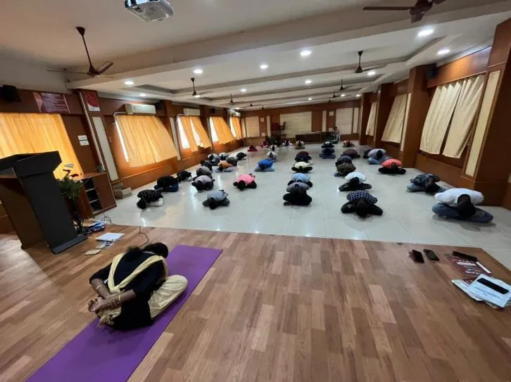 Mats laid out across the hall for an asana session
