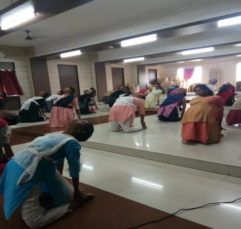 First-year students bending forward in rows