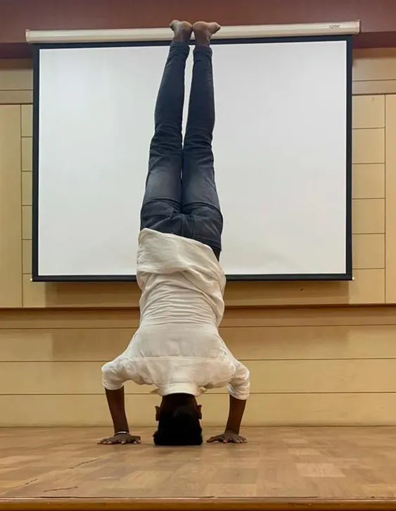 A student holding a headstand