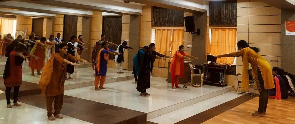 Students seated on the hall floor during the workshop