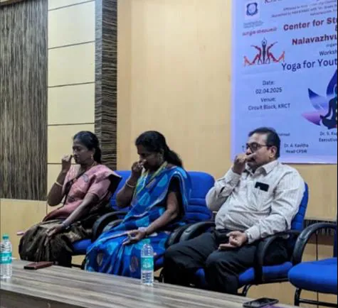Guests seated in front of the Yoga for Youth banner