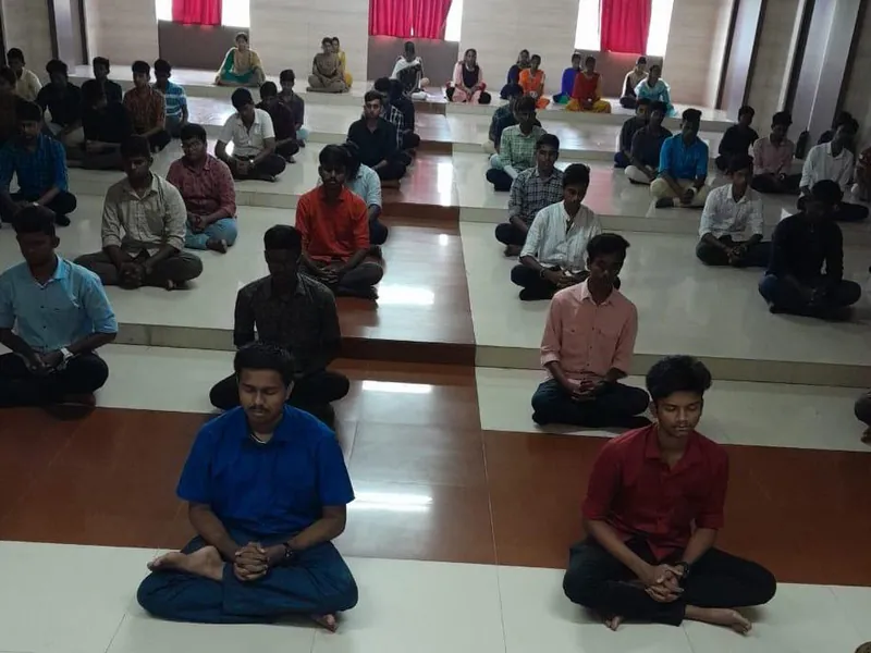Students seated in meditation during a yoga session